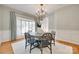 Formal dining room showcasing chandelier, wainscoting, and a large bay window at 6804 Riesman Ln, Charlotte, NC 28210