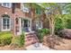 Inviting front porch with brick steps, iron railings and detailed trim around the front door at 6804 Riesman Ln, Charlotte, NC 28210