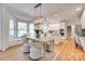 Eat-in kitchen area with bright white cabinets, stainless appliances, and a cozy seating area at 6804 Riesman Ln, Charlotte, NC 28210