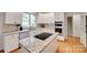 Well-lit kitchen featuring granite countertops, stainless steel appliances, and white cabinetry at 6804 Riesman Ln, Charlotte, NC 28210