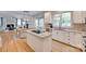 Open-concept kitchen with an island cooktop, white cabinets and seamless flow to the dining area at 6804 Riesman Ln, Charlotte, NC 28210