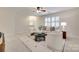 Comfortable living area with white seating, decorative rug, and lots of natural light at 6804 Riesman Ln, Charlotte, NC 28210