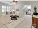 Bright sitting room with neutral decor, plantation shutters, and view into office at 6804 Riesman Ln, Charlotte, NC 28210