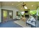 Inviting outdoor living space featuring a stone fireplace, comfortable seating, and a stylish ceiling fan at 6804 Riesman Ln, Charlotte, NC 28210
