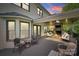 Covered porch with stone fireplace, tv, comfortable seating and wooded backyard views at 6804 Riesman Ln, Charlotte, NC 28210