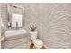 Stylish powder room with zebra-striped wallpaper, modern vanity, and elegant fixtures at 6804 Riesman Ln, Charlotte, NC 28210