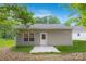 Backyard exterior of home featuring manicured lawn, patio and tan vinyl siding at 699 Jackson Sw Ter, Concord, NC 28027