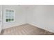 Bedroom with neutral walls, plush carpet, and a window at 699 Jackson Sw Ter, Concord, NC 28027