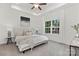 Bright main bedroom with tray ceiling, ceiling fan, large window, and plush carpeting at 699 Jackson Sw Ter, Concord, NC 28027