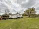 Large backyard features a covered gazebo, a mature shade tree, and a well-maintained lawn at 7514 Secrest Shortcut Rd, Indian Trail, NC 28079