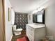 Bright bathroom boasts a white vanity with marble countertop and a decorative shower curtain at 7514 Secrest Shortcut Rd, Indian Trail, NC 28079