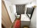 Cozy bathroom features a decorative shower curtain, modern vanity, and wood-look flooring at 7514 Secrest Shortcut Rd, Indian Trail, NC 28079