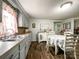 Bright kitchen with painted cabinets and floral tablecloth-covered table, blending charm with functionality and style at 7514 Secrest Shortcut Rd, Indian Trail, NC 28079