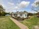 Quaint home with manicured landscaping, a welcoming walkway, and a charming covered porch at 7514 Secrest Shortcut Rd, Indian Trail, NC 28079
