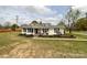 Charming one-story home features an inviting front porch and beautiful landscaping at 7514 Secrest Shortcut Rd, Indian Trail, NC 28079