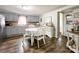 Charming eat-in kitchen with painted cabinets, floral accents, and hardwood floors, blending functionality with rustic style at 7514 Secrest Shortcut Rd, Indian Trail, NC 28079