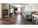 Open living room with dark-stained fireplace, hardwood floors, and comfortable sofa, perfect for Gathering gatherings at 7514 Secrest Shortcut Rd, Indian Trail, NC 28079