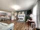 Spacious living room with fireplace, hardwood floors, and a dining area, creating a cohesive and inviting living space at 7514 Secrest Shortcut Rd, Indian Trail, NC 28079