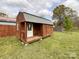 New outbuilding featuring board and batten siding and a small porch at 7514 Secrest Shortcut Rd, Indian Trail, NC 28079