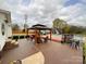 Relaxing outdoor patio with a gazebo, lounge furniture, a pool, and ample space for entertainment at 7514 Secrest Shortcut Rd, Indian Trail, NC 28079