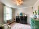 Sitting room featuring a decorative rug, black cabinet, and whimsical flamingo accents at 7514 Secrest Shortcut Rd, Indian Trail, NC 28079