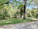 View of backyard showing shed and mature trees at 848 Woodland Rd, Statesville, NC 28677