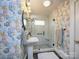 Modern bathroom with floral wallpaper, walk-in shower and pedestal sink at 848 Woodland Rd, Statesville, NC 28677