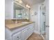 Bathroom featuring sink with vanity, tile floor and countertop, mirror, lighting, and view of open doorway at 848 Woodland Rd, Statesville, NC 28677