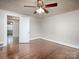 Bright bedroom with ceiling fan, hardwood flooring and doorway leading to a glimpse of other rooms at 848 Woodland Rd, Statesville, NC 28677