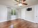 Bright bedroom with hardwood flooring, ceiling fan, double closet and window with wooded exterior view at 848 Woodland Rd, Statesville, NC 28677