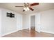 Bright bedroom with ceiling fan, hardwood flooring and double closet, and doorway leading to other rooms at 848 Woodland Rd, Statesville, NC 28677