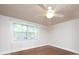 Bright bedroom with hardwood flooring, ceiling fan, window with sheer curtains, and neutral walls at 848 Woodland Rd, Statesville, NC 28677