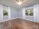 Bedroom with hardwood floors, two windows and white curtains at 848 Woodland Rd, Statesville, NC 28677