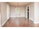 Bright dining room featuring hardwood floors, a chandelier, and natural light through large windows at 848 Woodland Rd, Statesville, NC 28677