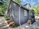 Side view of a gray brick home with black accents and landscaped grounds at 848 Woodland Rd, Statesville, NC 28677