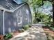 Side view of modern gray brick house with manicured landscaping and a paved driveway at 848 Woodland Rd, Statesville, NC 28677