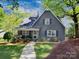 Charming single Gathering home with front porch and lush, mature landscaping at 848 Woodland Rd, Statesville, NC 28677