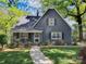 Charming home featuring landscaped front yard, covered porch, and inviting walkway at 848 Woodland Rd, Statesville, NC 28677