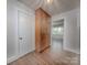 Hallway with hardwood floors and built-in storage with access to a bedroom at 848 Woodland Rd, Statesville, NC 28677