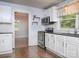 Stylish kitchen featuring white cabinets, subway tile backsplash, and stainless steel appliances at 848 Woodland Rd, Statesville, NC 28677