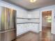 Well-lit kitchen with stainless steel refrigerator, white cabinetry, and subway tile backsplash at 848 Woodland Rd, Statesville, NC 28677