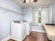 Laundry room with hardwood floors and stacked washer and dryer at 848 Woodland Rd, Statesville, NC 28677