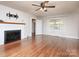 Bright living room with hardwood floors, fireplace, and large windows with sheer curtains at 848 Woodland Rd, Statesville, NC 28677