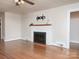 Inviting living room featuring a brick fireplace, hardwood floors, and ample natural light at 848 Woodland Rd, Statesville, NC 28677