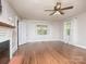Spacious living room featuring hardwood floors, a fireplace, and abundant natural light at 848 Woodland Rd, Statesville, NC 28677