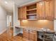 A home office is featured with custom shelves, granite counters and wood floors at 8912 Heydon Hall Cir, Charlotte, NC 28210
