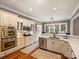 Modern kitchen with stainless steel appliances, white cabinets, hardwood floors, and an eat-in area at 8912 Heydon Hall Cir, Charlotte, NC 28210