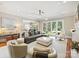 Bright and open living room with modern lighting, comfortable seating, and view into the backyard at 8912 Heydon Hall Cir, Charlotte, NC 28210