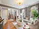 Bright living room featuring hardwood floors, large windows, stylish furnishings, and an open staircase at 8912 Heydon Hall Cir, Charlotte, NC 28210