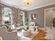 A luxurious living room featuring a patterned wall, rounded windows, and plush seating arrangement at 8912 Heydon Hall Cir, Charlotte, NC 28210